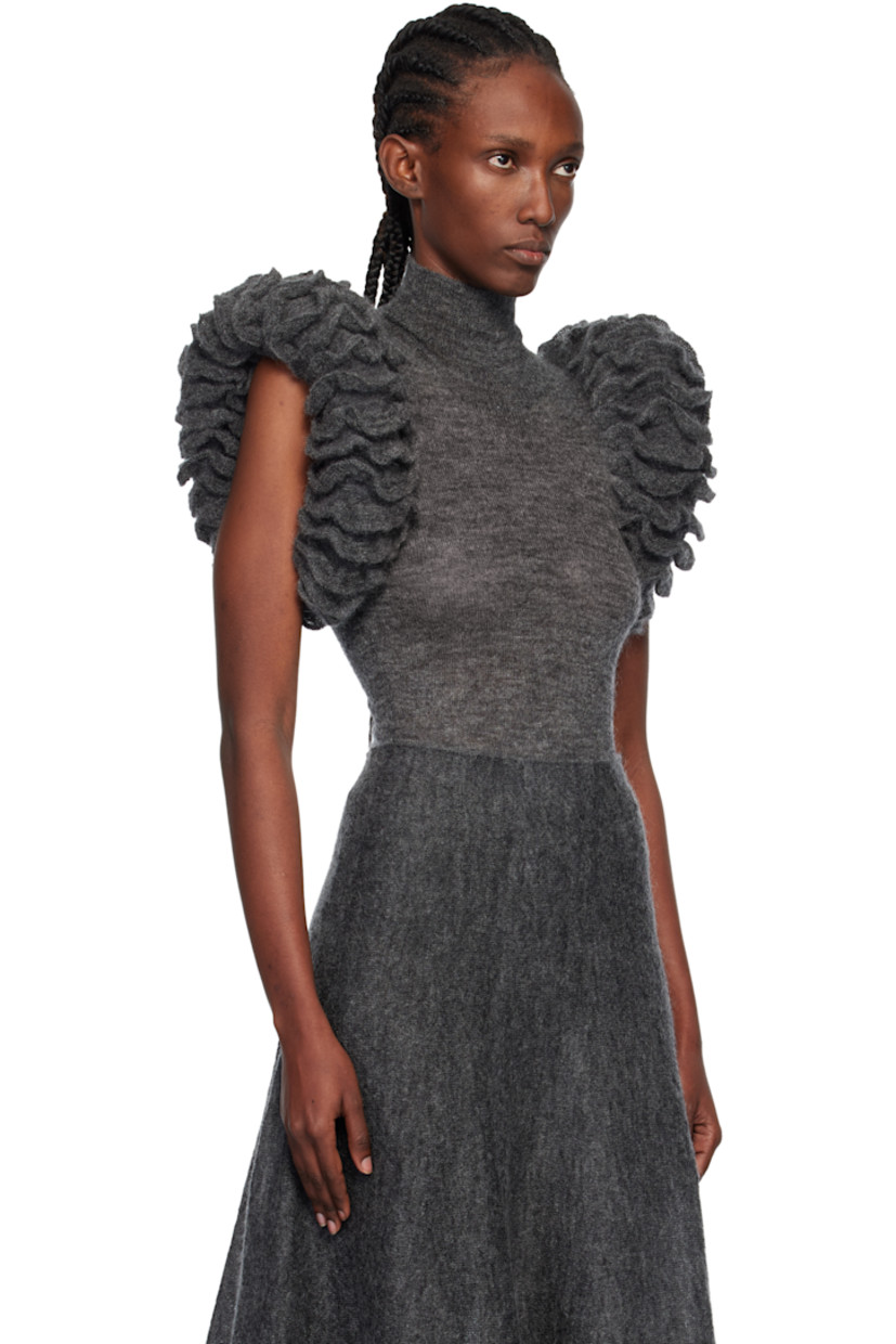 Semi-sheer knit mohair-blend bodysuit.

· Rib-knit turtleneck
· Padded ruffled trim at sleeves
· Press-stud closure at elasticized bottom

Supplier color: Gray