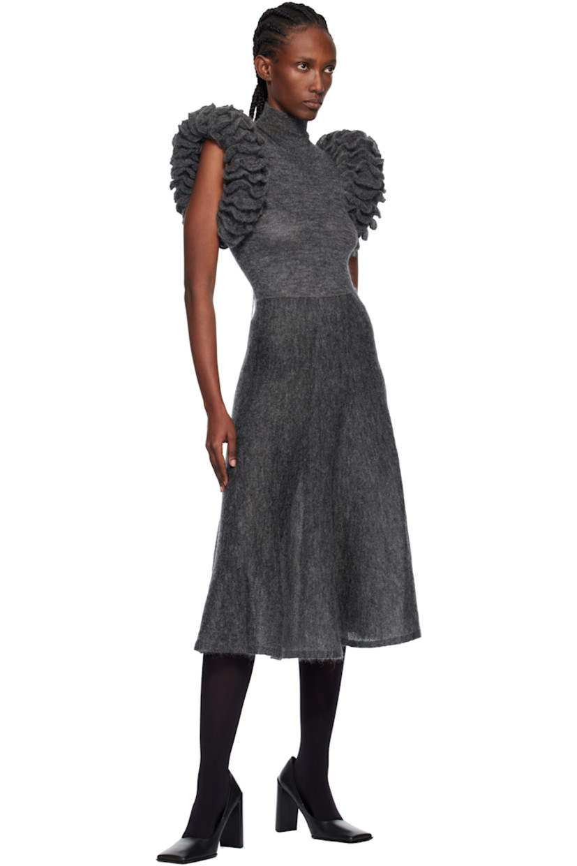 Semi-sheer knit mohair-blend bodysuit.

· Rib-knit turtleneck
· Padded ruffled trim at sleeves
· Press-stud closure at elasticized bottom

Supplier color: Gray