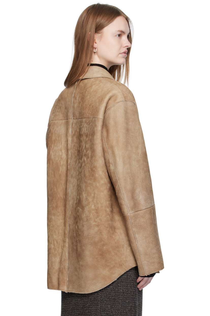 Paneled lambskin suede jacket.

· Exposed seams throughout
· Spread collar
· Button closure
· Patch pocket at chest
· Seam pockets at waist
· Shearling interior

Supplier color: Beige