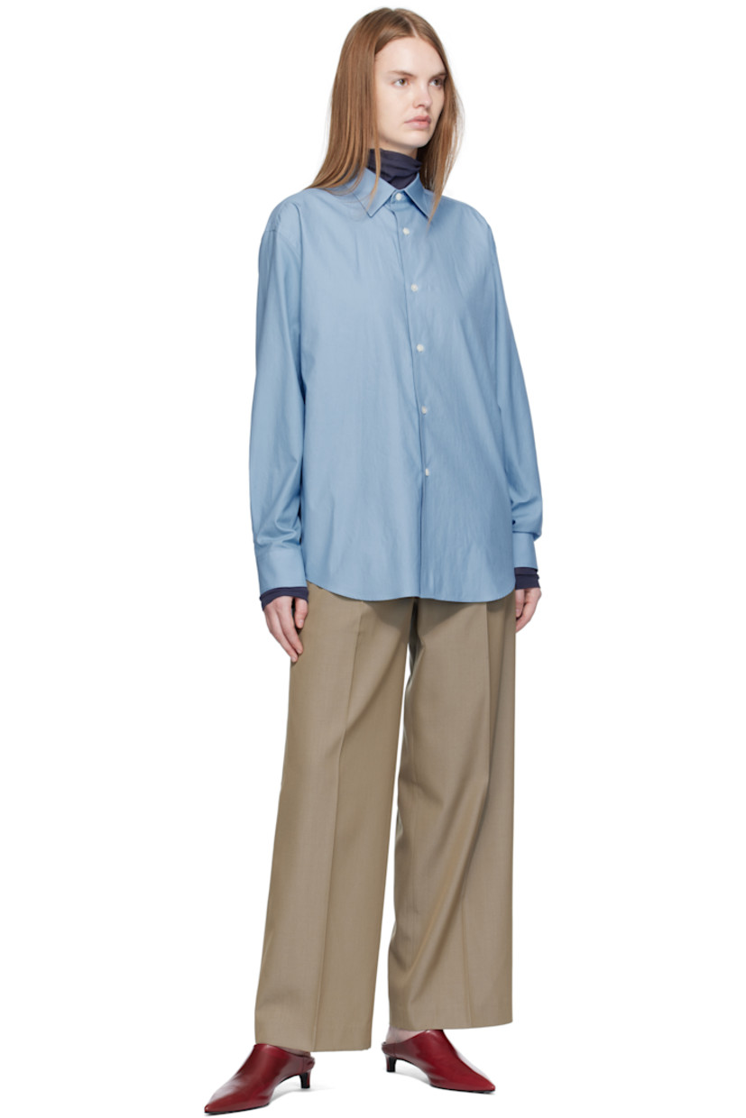 Lightweight wool gabardine trousers.

· Wide-leg
· Belt loops
· Four-pocket styling
· Zip fly
· Pleats at front
· Creased legs

Supplier color: Khaki chambray
