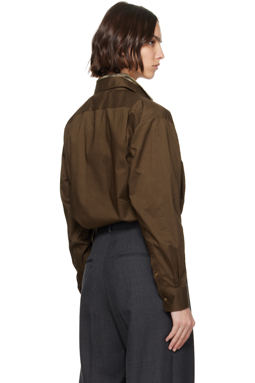 Oversized washed cotton poplin shirt.

· Spread collar
· Button closure
· Patch pocket at chest
· Droptail hem
· Buttoned barrel cuffs
· Twin pleats at back yoke
· Mother-of-pearl hardware

Supplier color: Dark brown