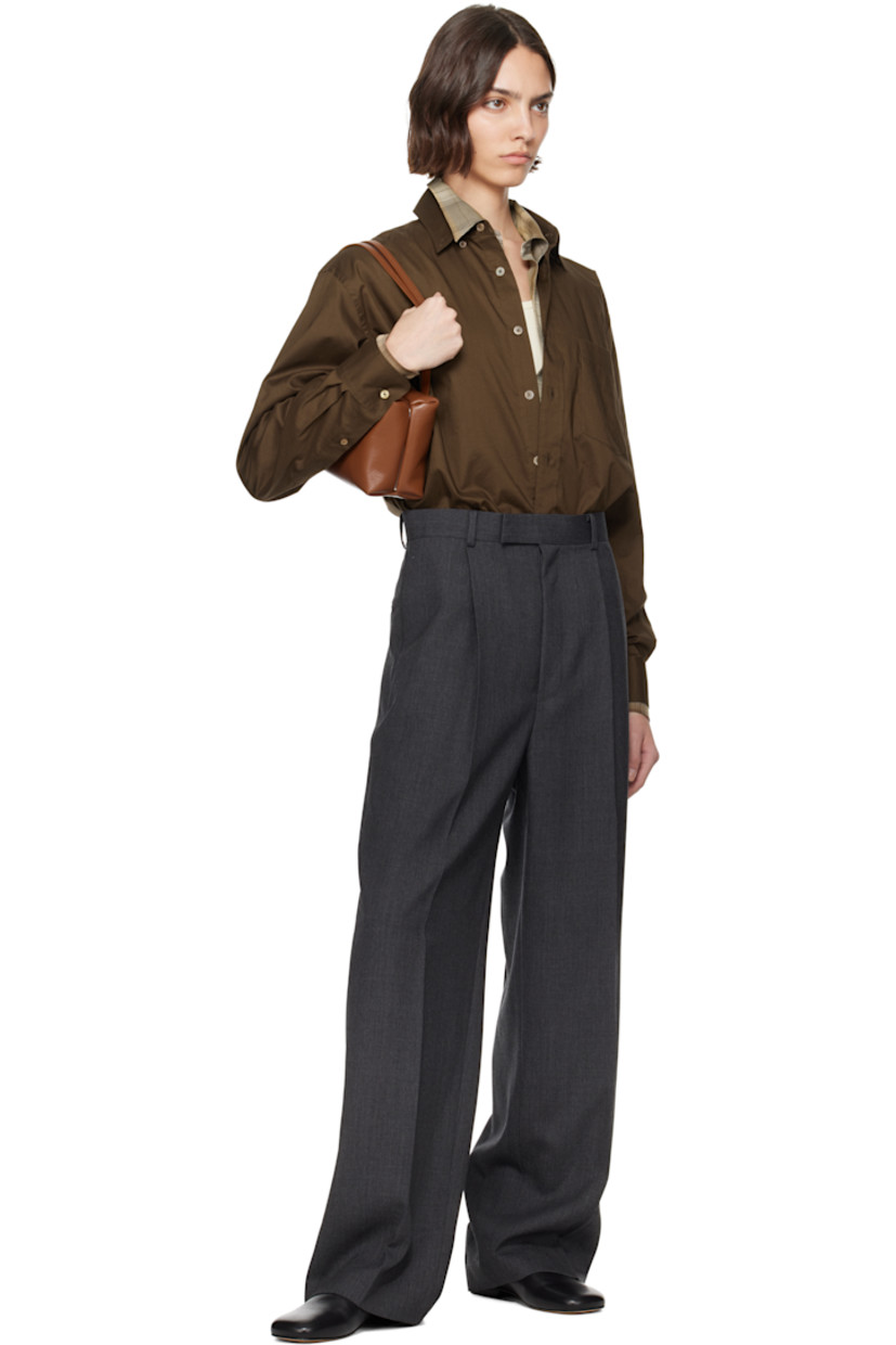 Oversized washed cotton poplin shirt.

· Spread collar
· Button closure
· Patch pocket at chest
· Droptail hem
· Buttoned barrel cuffs
· Twin pleats at back yoke
· Mother-of-pearl hardware

Supplier color: Dark brown