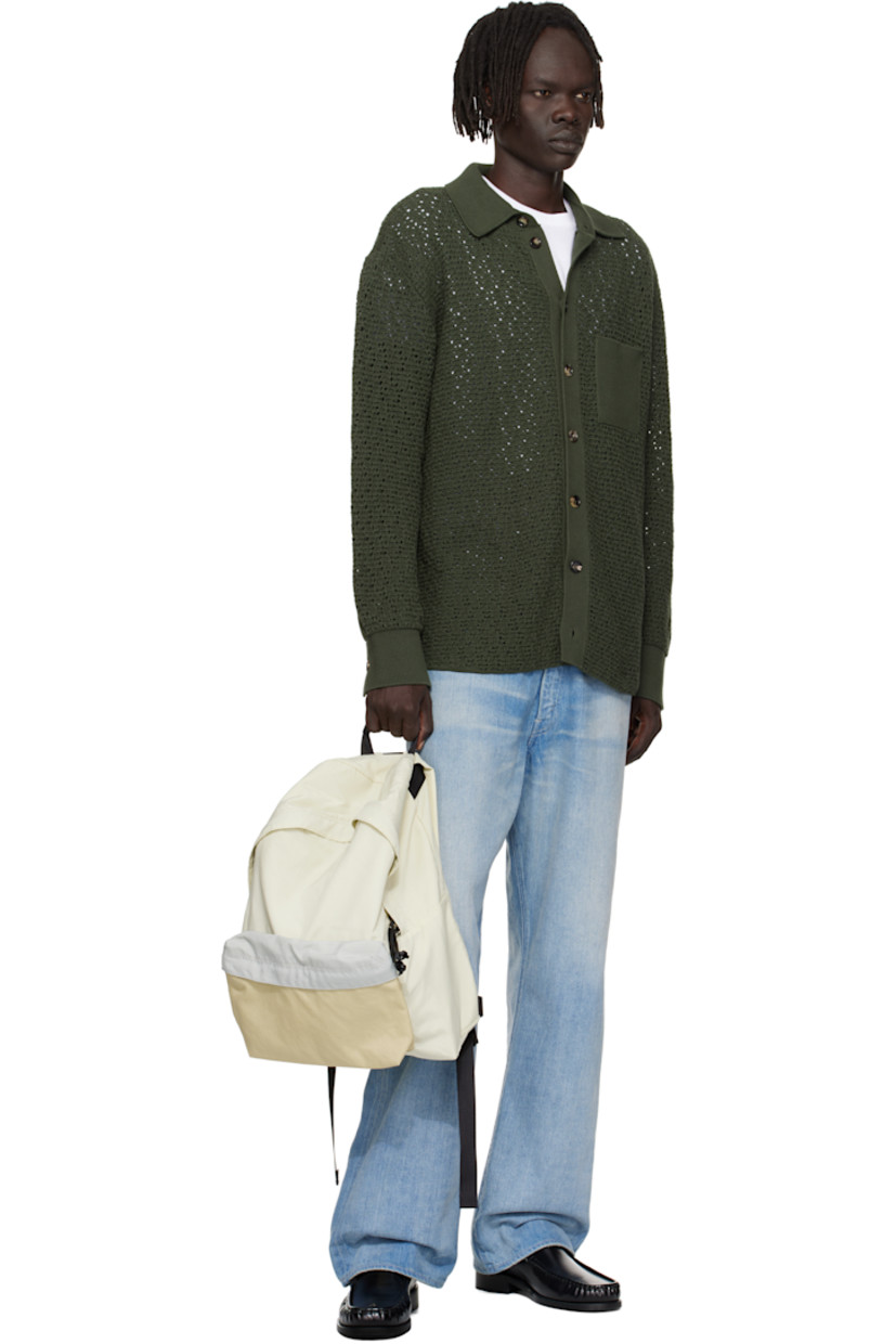 Nylon canvas backpack.

· 210 denier
· Fixed webbing and leather carry handle
· Adjustable padded shoulder straps
· Zip compartment at face
· Two-way zip closure
· Laptop compartment at interior
· Canvas lining
· H18" x W12" x D5.5"

Part of the AURALEE x AETA collaboration.

Supplier color: Ivory/Beige