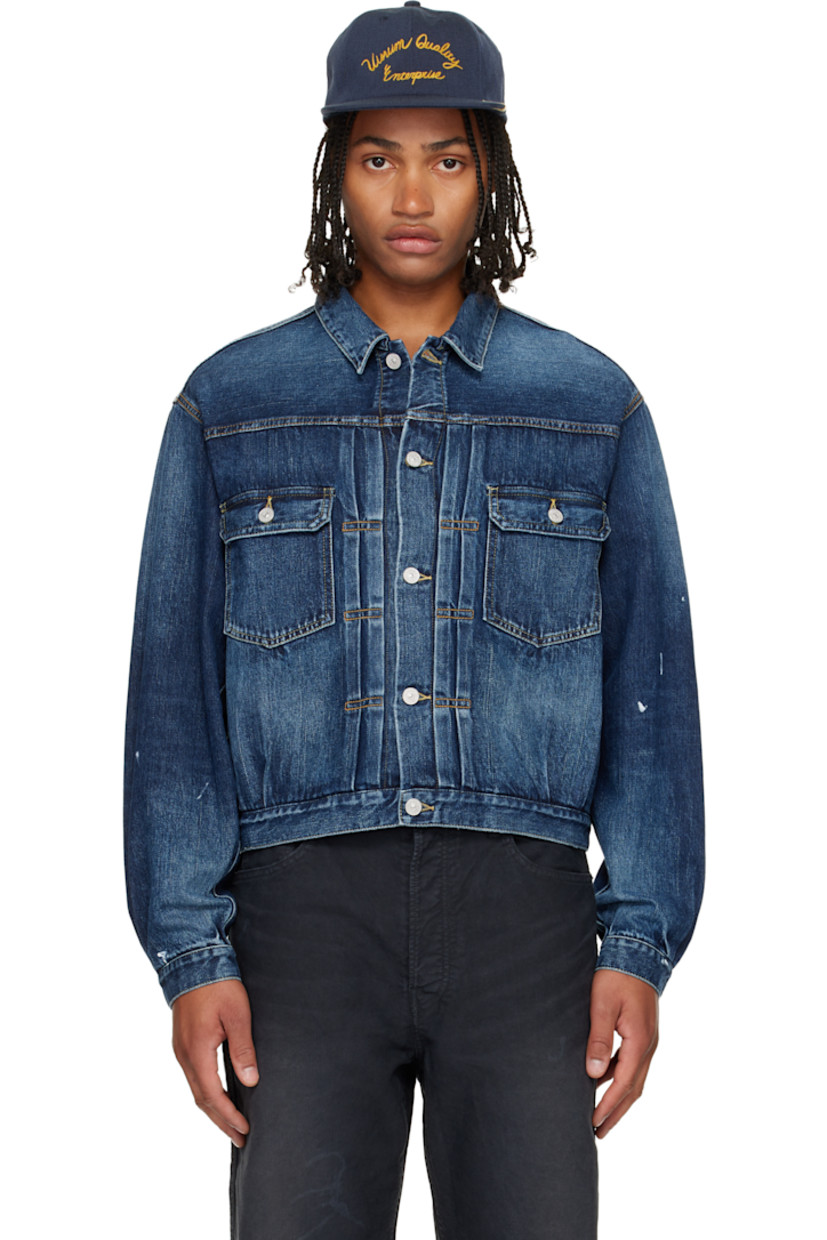 Non-stretch denim jacket.

· Fading throughout
· Spread collar
· Button closure
· Tucks at front
· Flap pockets at chest
· Seam pockets
· Buttoned barrel cuffs
· Adjustable button tabs and logo patch at back hem
· Contrast stitching in tan

Supplier color: Navy