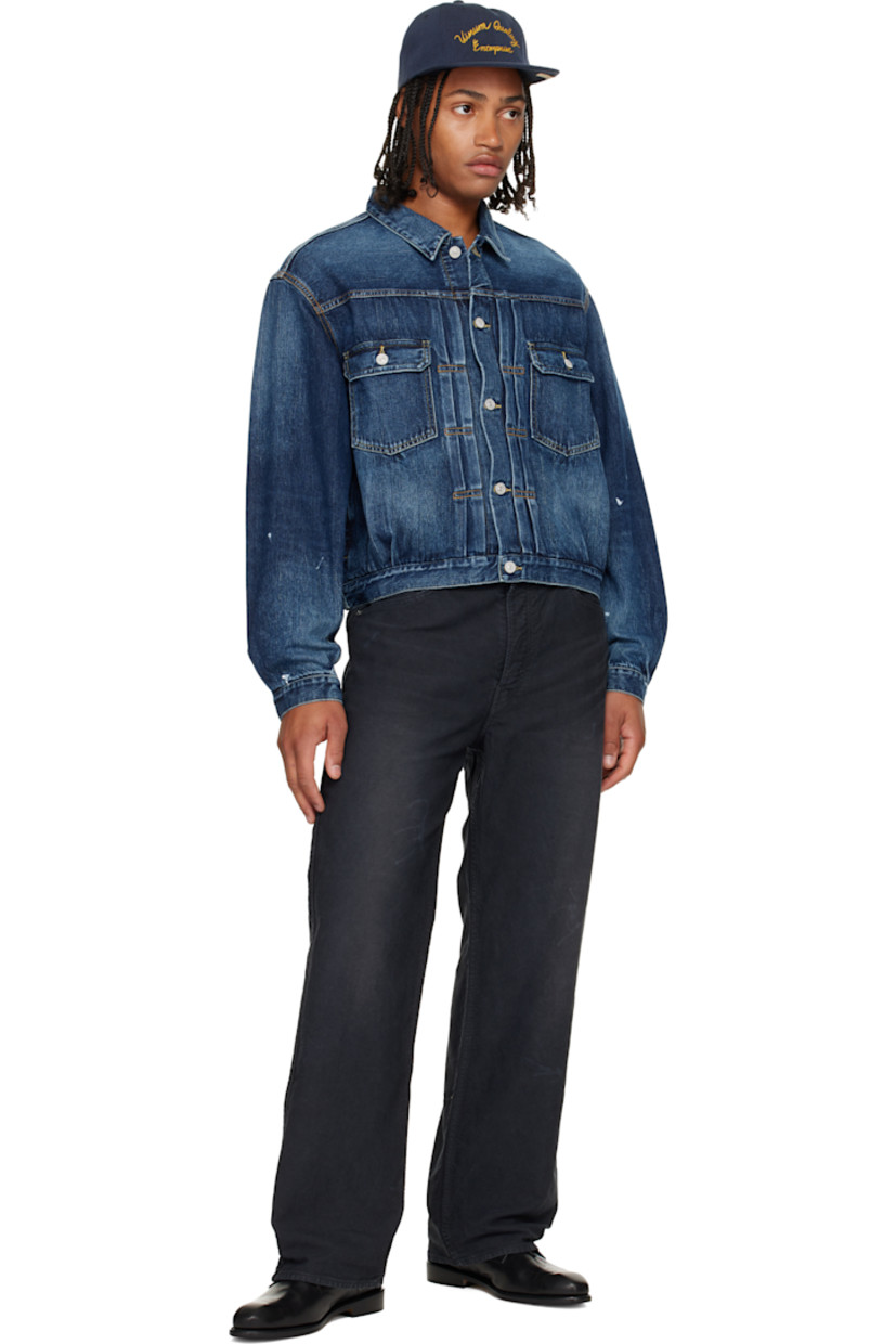 Non-stretch denim jacket.

· Fading throughout
· Spread collar
· Button closure
· Tucks at front
· Flap pockets at chest
· Seam pockets
· Buttoned barrel cuffs
· Adjustable button tabs and logo patch at back hem
· Contrast stitching in tan

Supplier color: Navy