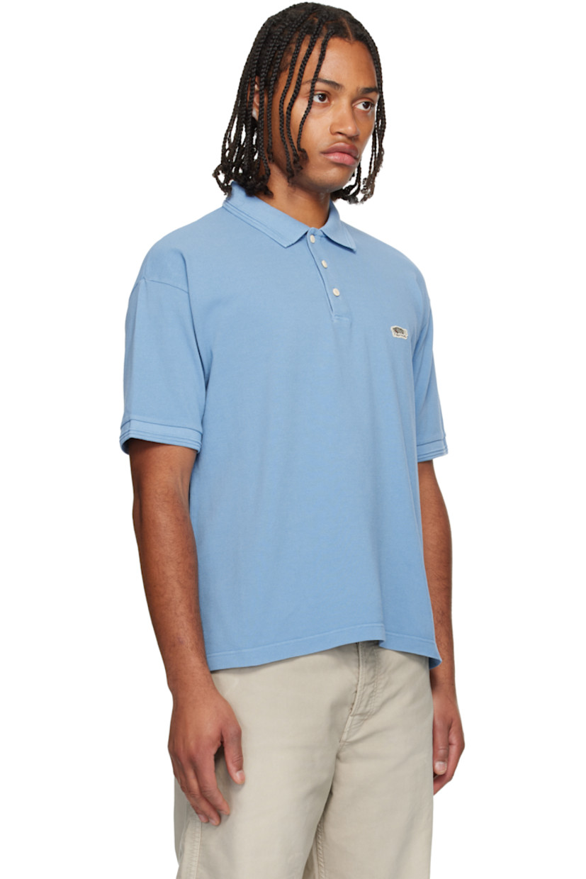 Cotton piqué polo. 

· Rib-knit spread collar and cuffs
· Three-button placket 
· Embroidered logo patch at chest
· Tennis-tail hem 

Supplier color: Lt blue