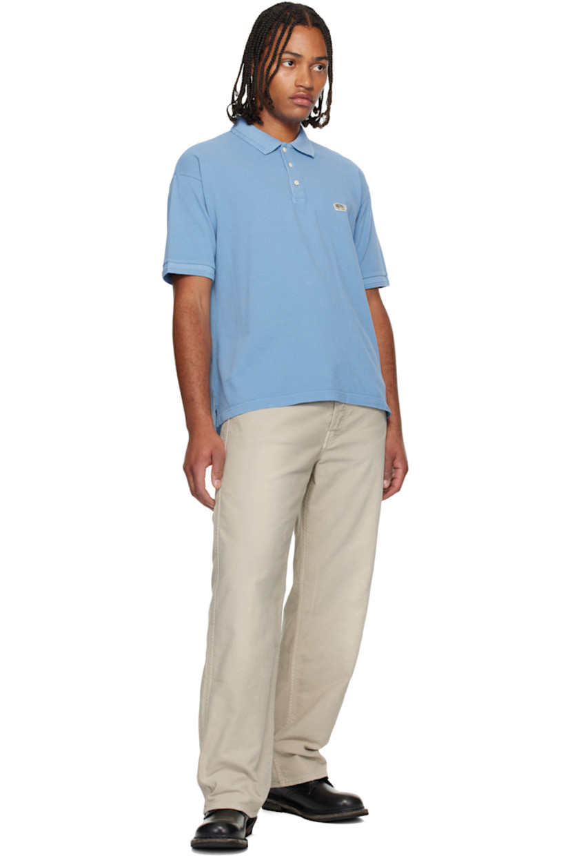 Cotton piqué polo. 

· Rib-knit spread collar and cuffs
· Three-button placket 
· Embroidered logo patch at chest
· Tennis-tail hem 

Supplier color: Lt blue