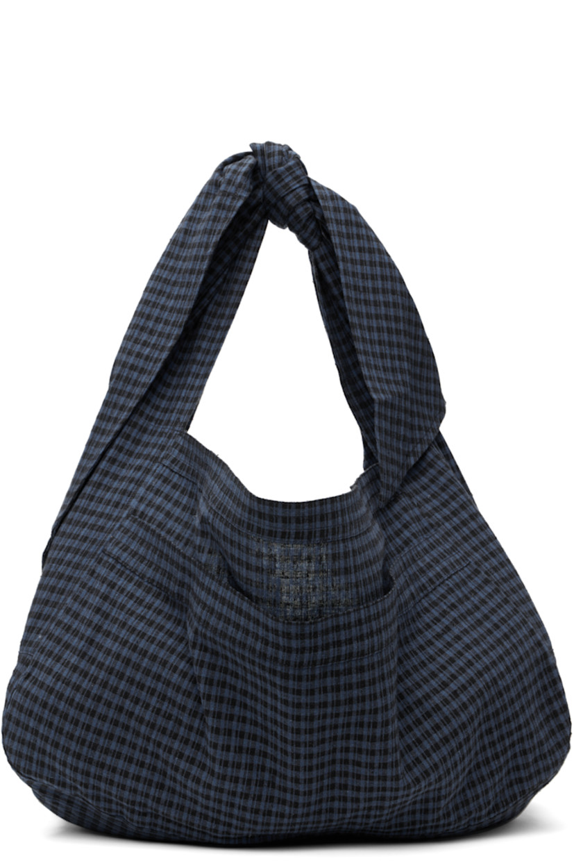 Cotton- and linen-blend flannel messenger bag in navy and black.

· Jacquard check pattern throughout
· Adjustable self-tie crossbody strap
· Patch pocket at face
· Open throat
· H11" x W17" x D8"

Available exclusively at SSENSE.

Supplier color: Basin