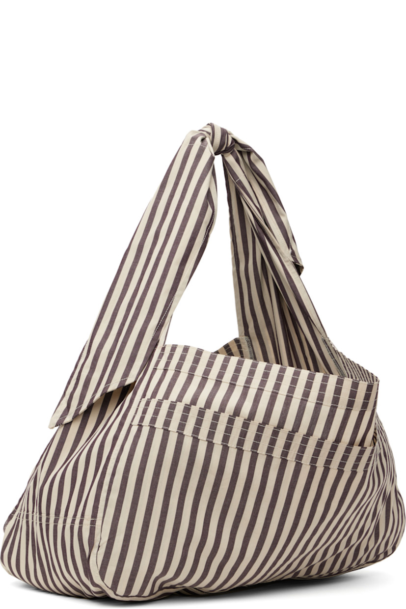 Cotton poplin shoulder bag in taupe and off-white.

· Stripes throughout
· Adjustable self-tie crossbody strap
· Patch pocket at face
· Open throat
· Unlined
· H10.5" x W18" x D7.5"

Supplier color: Net