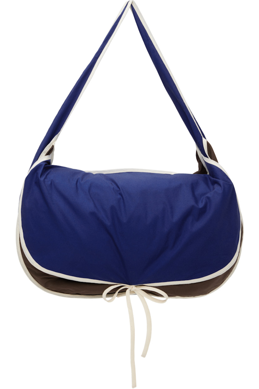Cotton poplin messenger bag in blue, brown, and off-white.

· Colorblocked
· Integrated crossbody strap
· Concealed patch pocket at face
· Self-tie flap closure
· Patch pocket at interior
· H14" x W22" x D5"

Supplier color: Relay