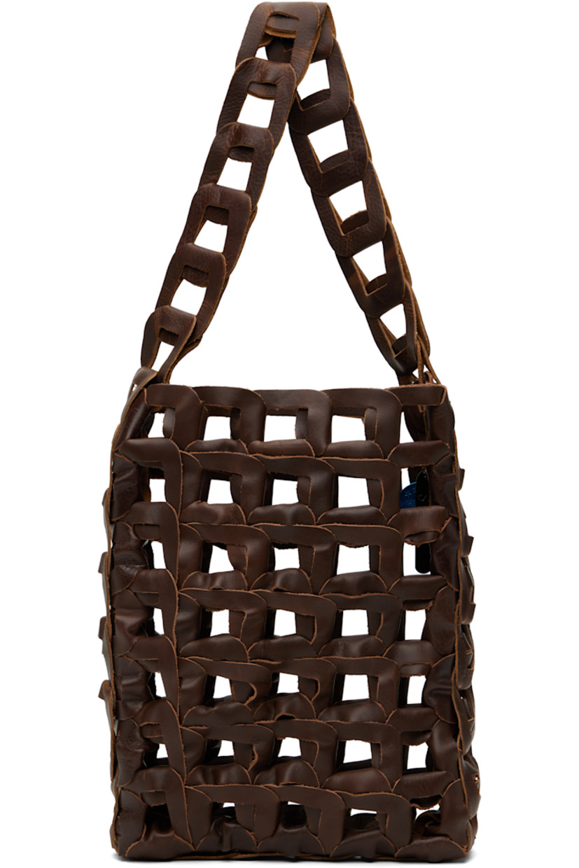 Handcrafted woven grained calfskin tote in brown.

· Fixed shoulder strap
· Open throat
· Logo charms at interior
· H13" x W9.5" x D2"

Each item is unique. Please note finishings may vary.

Available exclusively at SSENSE.

Supplier color: Solid brown