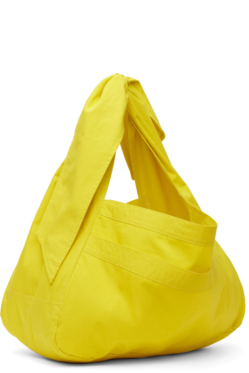 Cotton poplin tote in yellow.

· Adjustable self-tie crossbody strap
· Patch pocket at face
· Open throat
· Unlined
· H10.5" x W18" x D7.5"

Available exclusively at SSENSE.

Supplier color: Energy