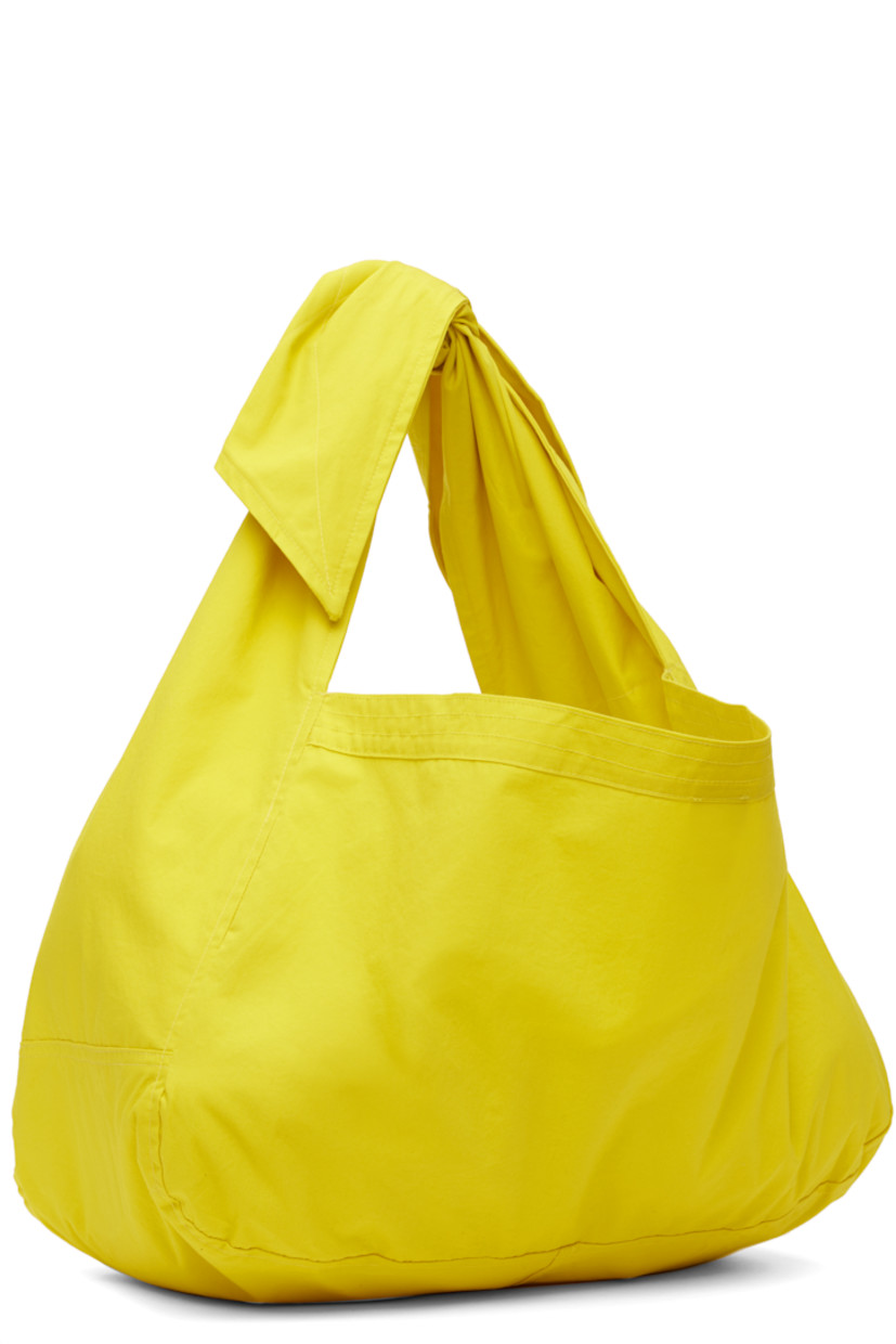 Cotton poplin tote in yellow.

· Adjustable self-tie crossbody strap
· Patch pocket at face
· Open throat
· Unlined
· H10.5" x W18" x D7.5"

Available exclusively at SSENSE.

Supplier color: Energy