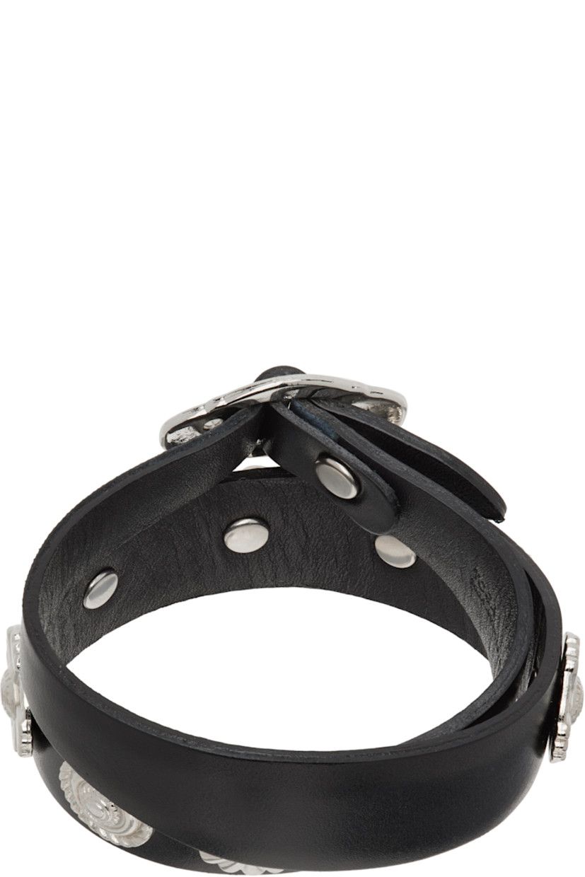 Wraparound buffed leather bracelet in black.

· Engraved hardware throughout 
· Cinch fastening 
· Silver-tone hardware
· L16"

Supplier color: Black