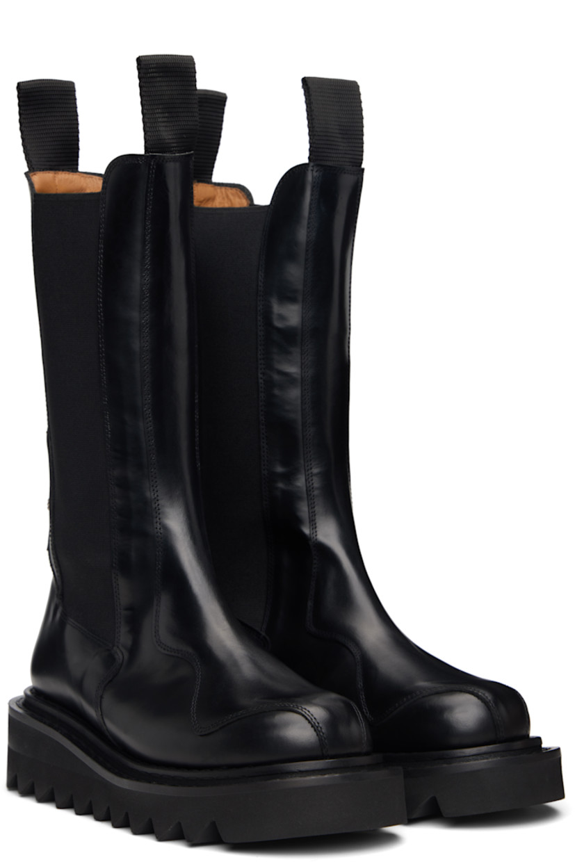 Mid-calf buffed leather Chelsea boots.

· Lace-up closure
· Pull-loops at collar
· Elasticized gusset at sides
· Graphic hardware at heel
· Foam rubber midsole 
· Treaded rubber sole

Available exclusively at SSENSE.

Supplier color: Black
