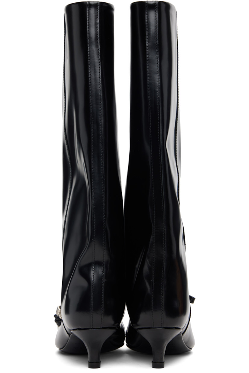 Knee-high polished leather boots.

· Pointed toe
· Knotted straps with O-rings at vamp
· Buffed leather lining
· Covered kitten heel with rubber injection
· Leather sole
· Heel: H1.5"

Supplier color: Black