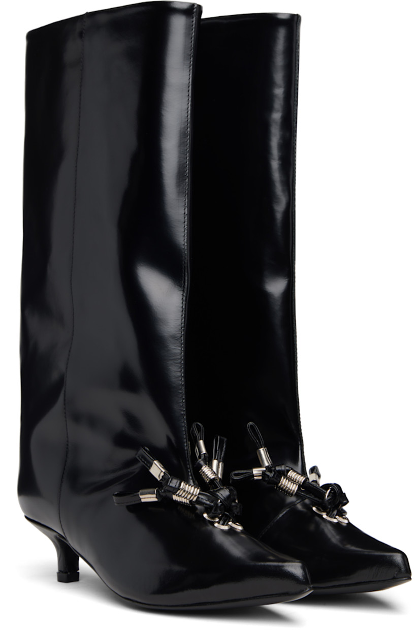 Knee-high polished leather boots.

· Pointed toe
· Knotted straps with O-rings at vamp
· Buffed leather lining
· Covered kitten heel with rubber injection
· Leather sole
· Heel: H1.5"

Supplier color: Black