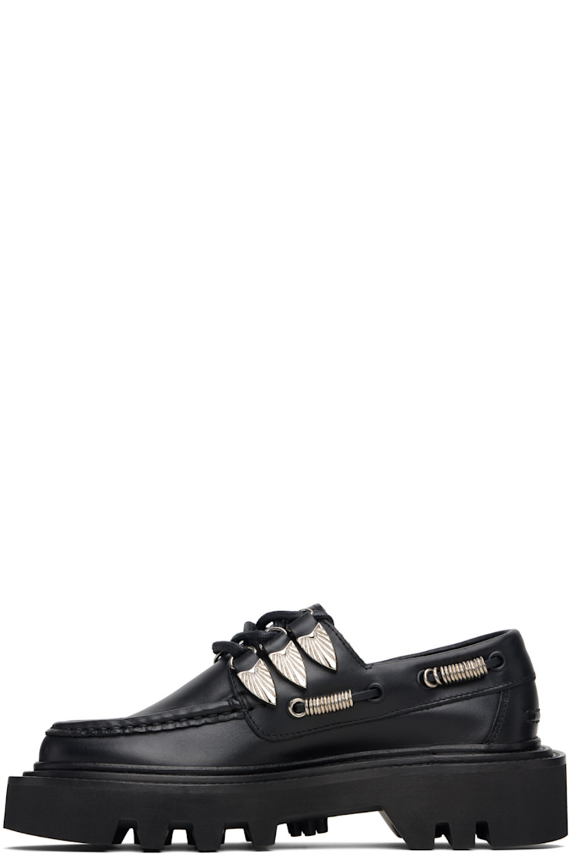 Buffed leather boat shoes.

· Moc toe
· Graphic hardware at lace-up closure
· Cord with O-rings at sides
· Pinched seam at heel counter
· Topstitching at welt
· Foam rubber midsole
· Treaded rubber sole

Supplier color: Black