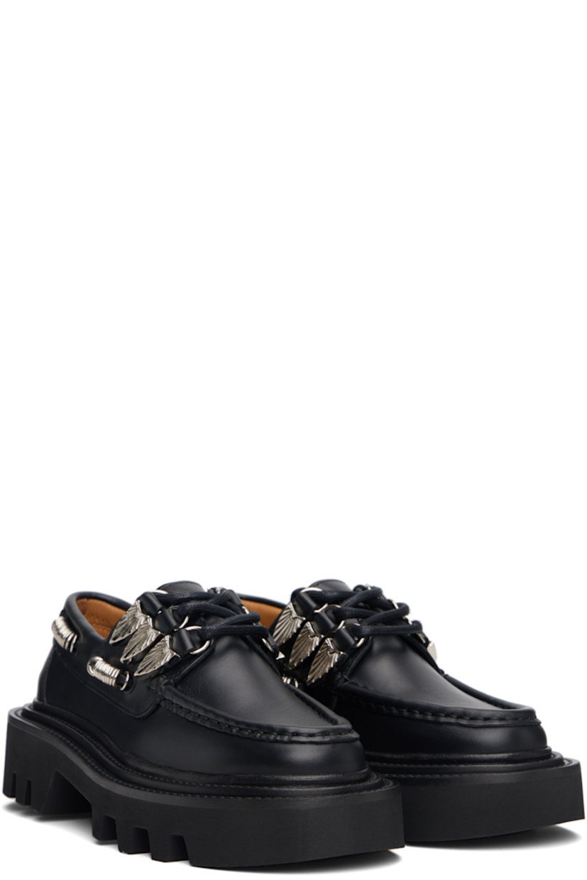 Buffed leather boat shoes.

· Moc toe
· Graphic hardware at lace-up closure
· Cord with O-rings at sides
· Pinched seam at heel counter
· Topstitching at welt
· Foam rubber midsole
· Treaded rubber sole

Supplier color: Black