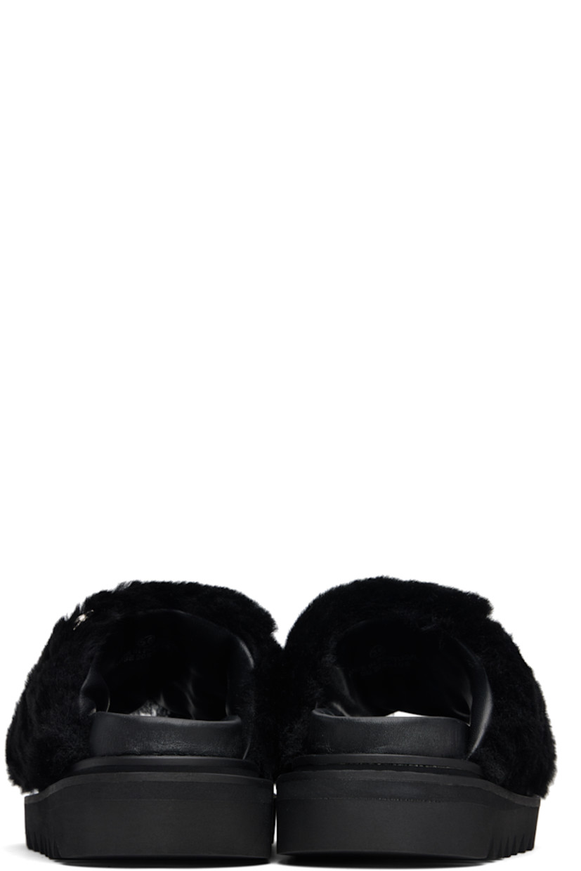 Shearling slippers. 

· Engraved graphic studs throughout 
· Open toe 
· Logo stamp at molded footbed 
· Treaded foam rubber sole
· Platform: H1.5"

Supplier color: Black fur