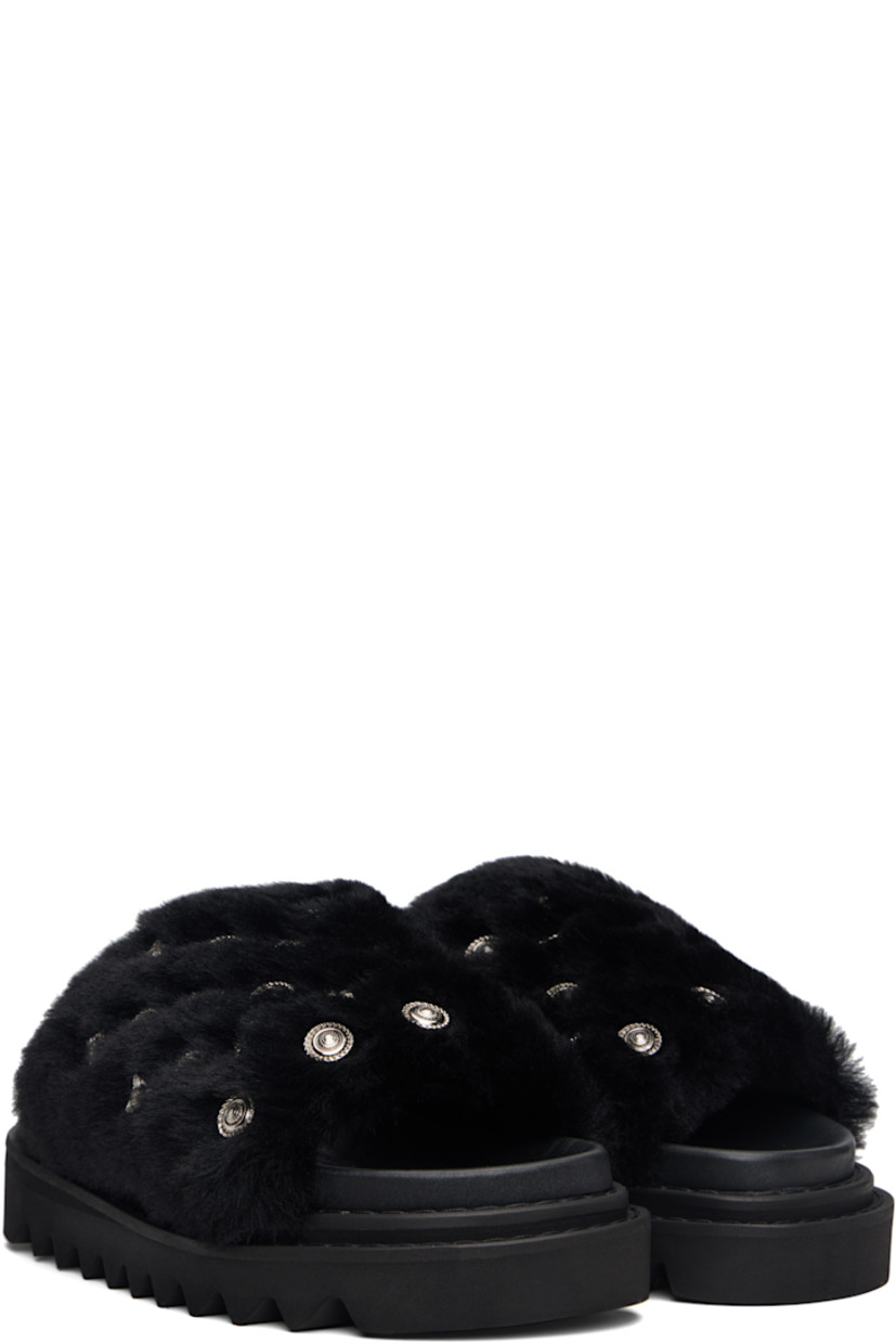 Shearling slippers. 

· Engraved graphic studs throughout 
· Open toe 
· Logo stamp at molded footbed 
· Treaded foam rubber sole
· Platform: H1.5"

Supplier color: Black fur