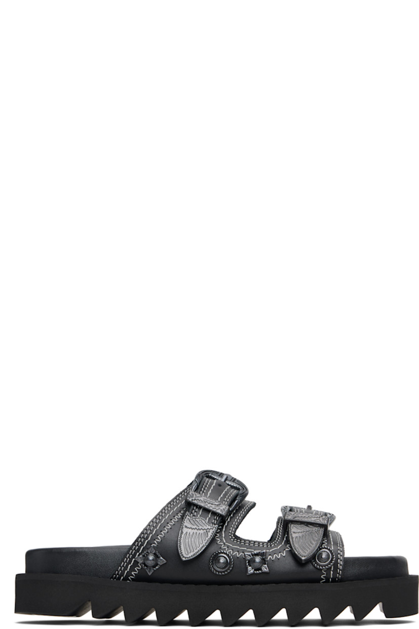 Buffed leather flats sandals.

· Graphic hardware throughout
· Open toe
· Pin-buckle straps at vamp
· Logo stamp at molded footbed
· Treaded rubber sole
· Contrast stitching in white

Supplier color: Black