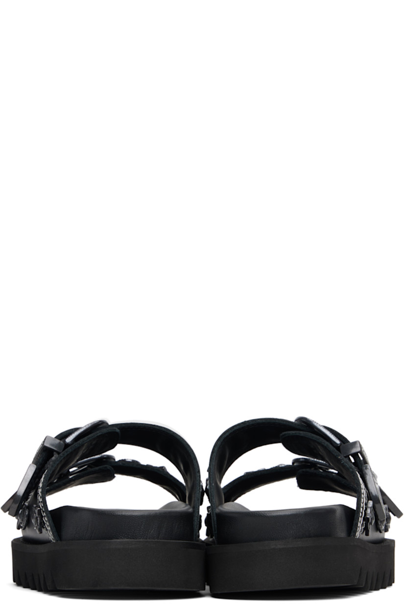 Buffed leather flats sandals.

· Graphic hardware throughout
· Open toe
· Pin-buckle straps at vamp
· Logo stamp at molded footbed
· Treaded rubber sole
· Contrast stitching in white

Supplier color: Black