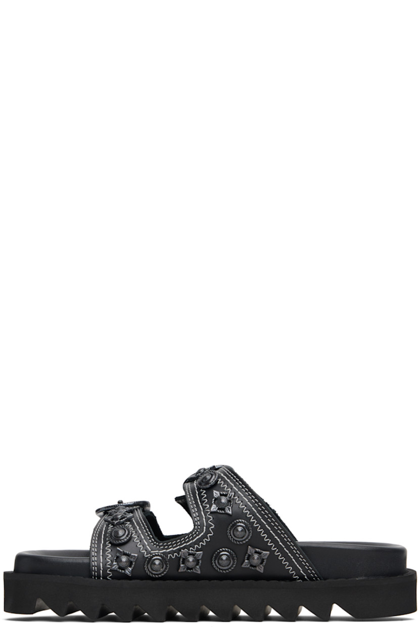 Buffed leather flats sandals.

· Graphic hardware throughout
· Open toe
· Pin-buckle straps at vamp
· Logo stamp at molded footbed
· Treaded rubber sole
· Contrast stitching in white

Supplier color: Black