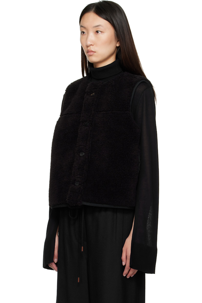 Reversible faux-suede vest.

Reverse in black faux-shearling.

· Round neck
· Button closure
· Seam pockets

Supplier color: Black