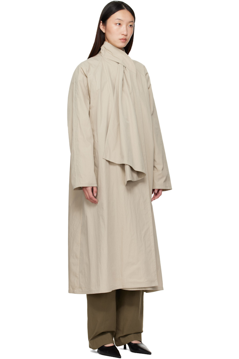 Cotton- and nylon-blend canvas trench coat. 

· Integrated self-tie scarf at shawl collar 
· Button fastening at collar 
· Open front 
· Welt pockets 
· Raglan sleeves 
· Unlined

Supplier color: Beige