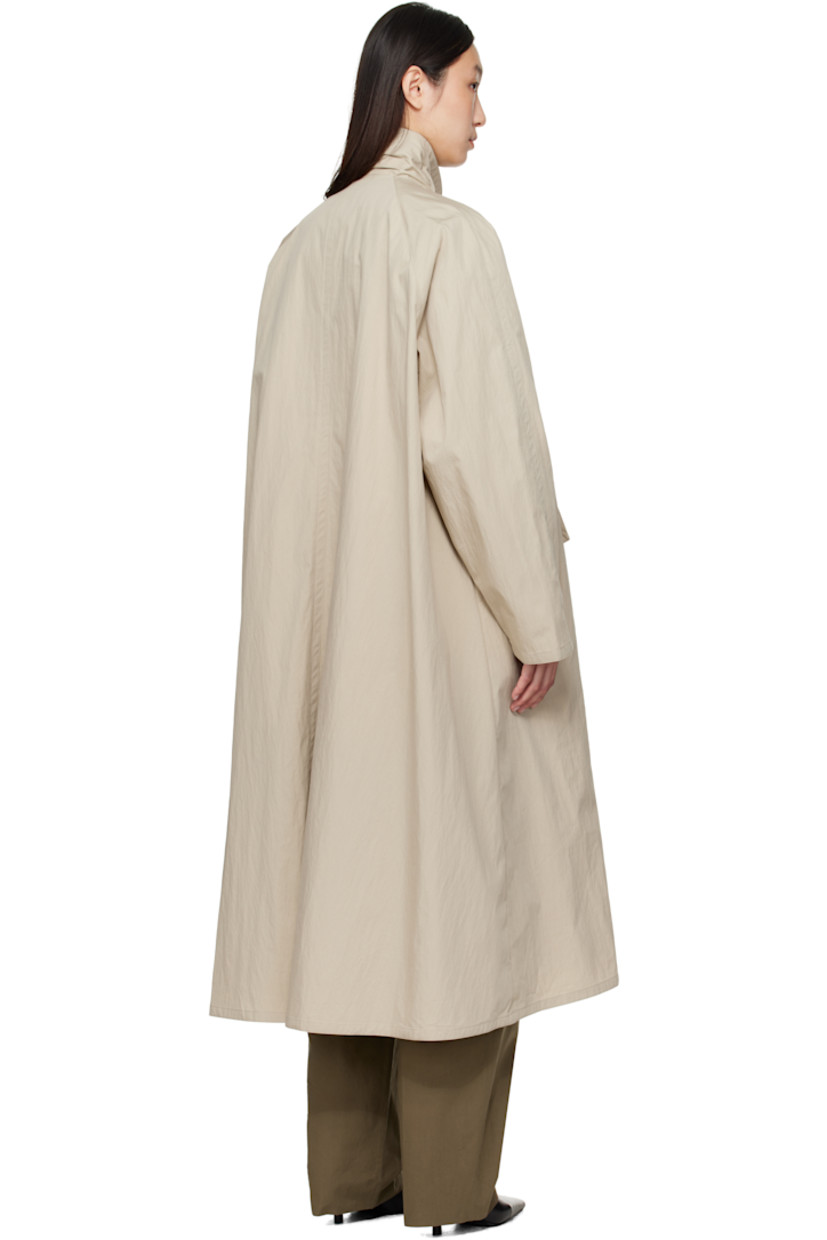 Cotton- and nylon-blend canvas trench coat. 

· Integrated self-tie scarf at shawl collar 
· Button fastening at collar 
· Open front 
· Welt pockets 
· Raglan sleeves 
· Unlined

Supplier color: Beige