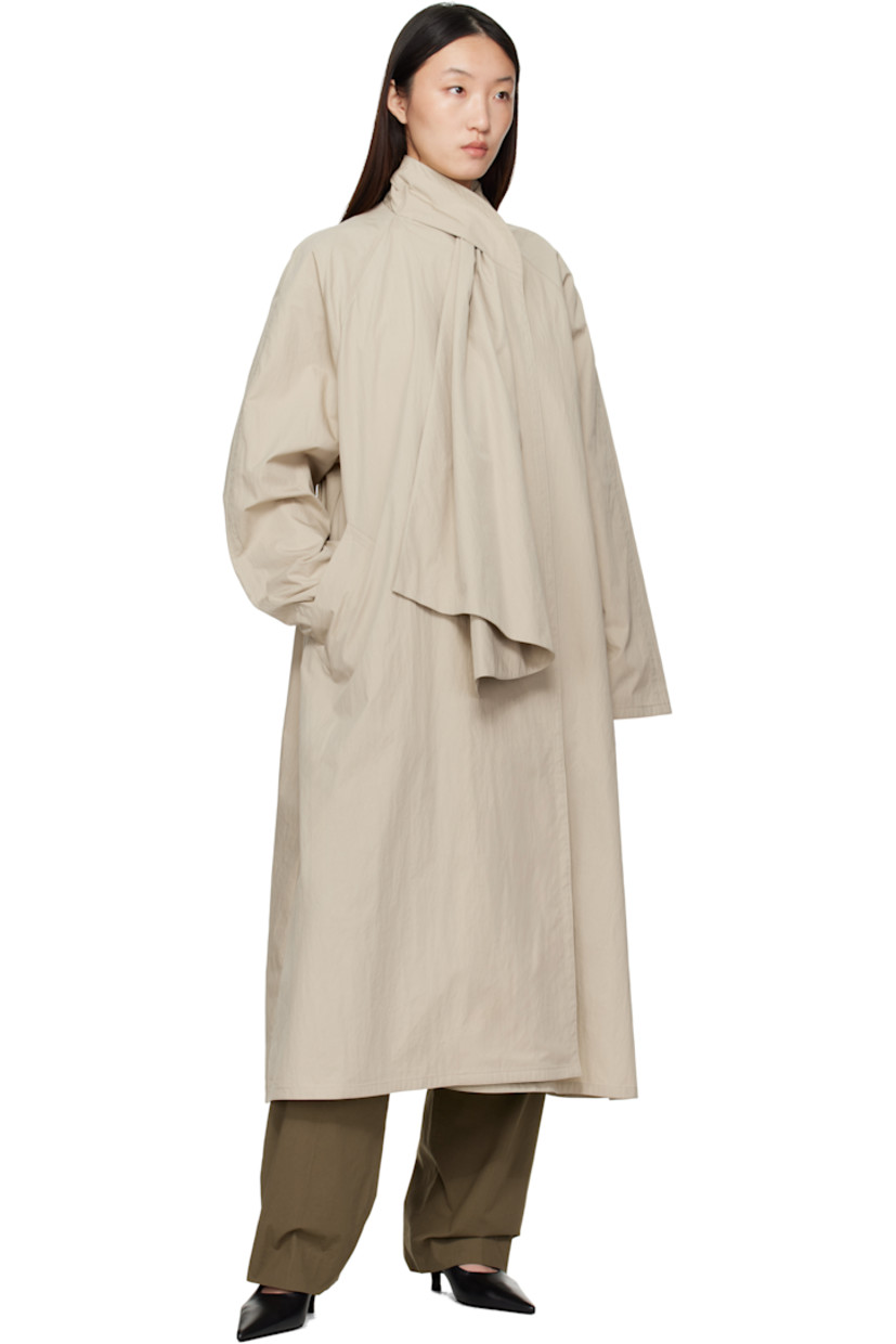 Cotton- and nylon-blend canvas trench coat. 

· Integrated self-tie scarf at shawl collar 
· Button fastening at collar 
· Open front 
· Welt pockets 
· Raglan sleeves 
· Unlined

Supplier color: Beige