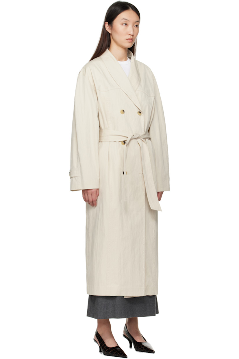 Crinkled cotton- and nylon-blend twill trench coat. 

· Shawl collar 
· Double-breasted button closure
· Seam pockets
· Belt loops and detachable self-tie belt 
· Button tab at cuffs
· Inverted box pleat with button tab at back hem 
· Welt pocket at interior 
· Full plain-woven cotton lining 

Supplier color: Ivory