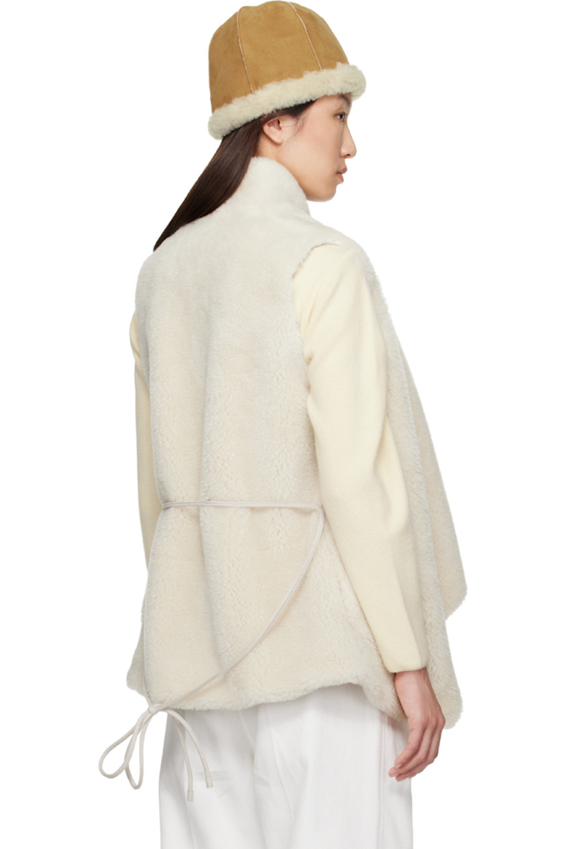Faux-shearling vest. 

· Shawl collar
· Detachable self-tie belt at waist
· Microfibre lining

Supplier color: Ivory