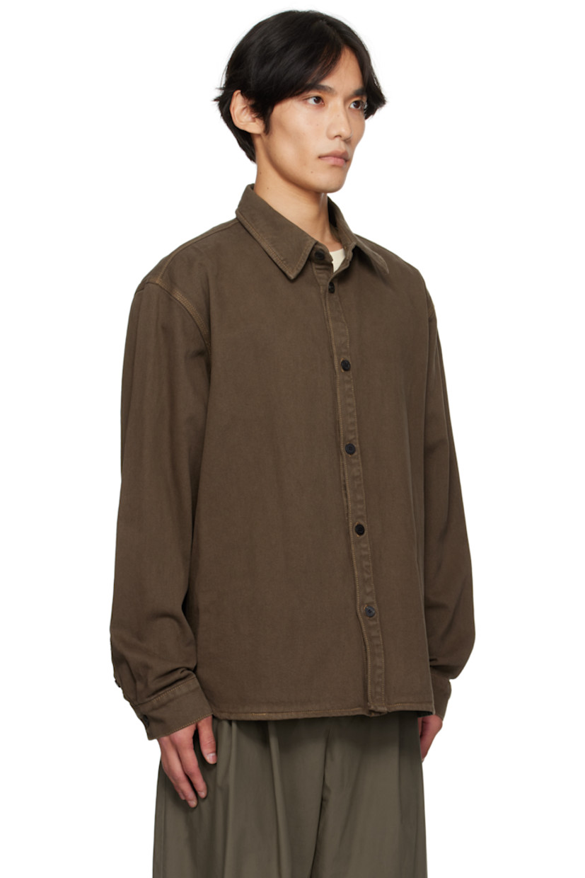 Non-stretch denim shirt.

· Spread collar 
· Button closure
· Shirttail hem 
· Dropped shoulders
· Buttoned barrel cuffs
· Logo hardware at back collar
· Central seam at back
· Contrast stitching in tan 

Supplier color: Brown