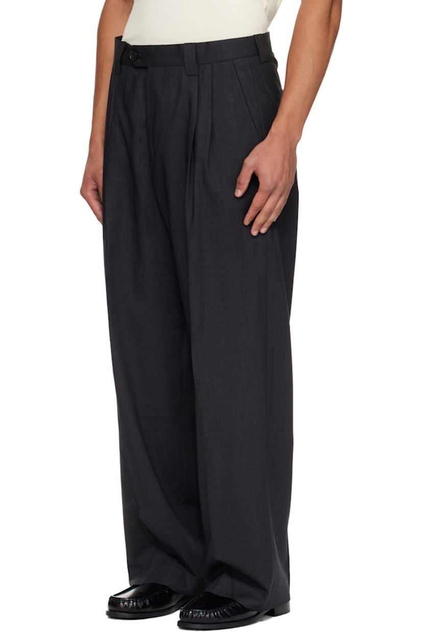 Deadstock wool delaine trousers.

· Wide straight-leg
· Mid-rise
· Belt loops
· Four-pocket styling
· Zip fly
· Pleats at front
· Creased legs
· Partial satin lining

Supplier color: Dark grey wool