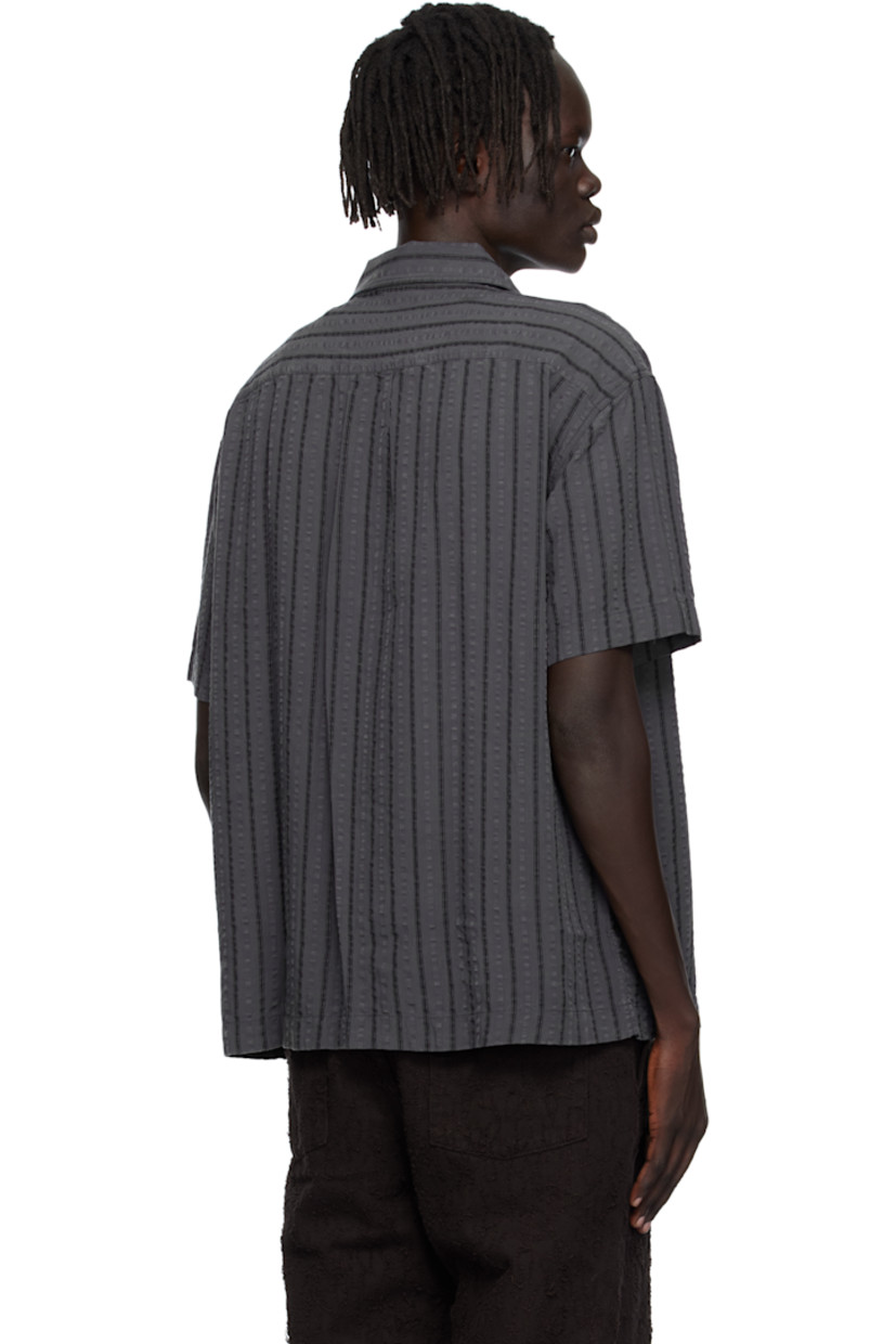 Tencel seersucker shirt.

· Stripes throughout
· Spread collar
· Button closure
· Box pleat at back yoke

Available exclusively at SSENSE.

Supplier color: Dark grey stripe