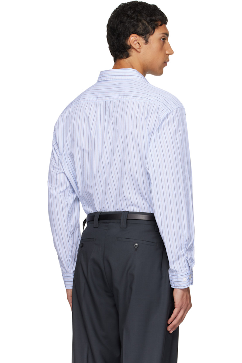 Cotton poplin shirt.

· Stripes throughout
· Spread collar
· Button closure
· Shirttail hem
· Dropped shoulders
· Adjustable buttoned barrel cuffs
· Box pleat at back yoke

Available exclusively at SSENSE.

Supplier color: Blue regent stripe