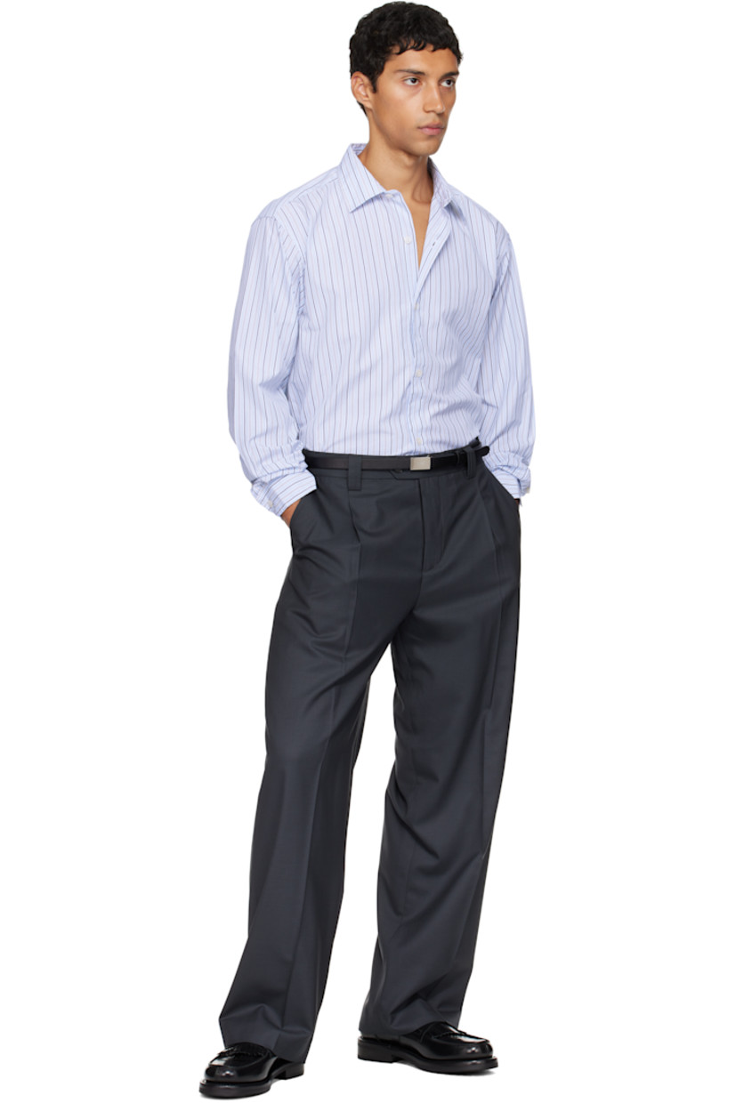 Cotton poplin shirt.

· Stripes throughout
· Spread collar
· Button closure
· Shirttail hem
· Dropped shoulders
· Adjustable buttoned barrel cuffs
· Box pleat at back yoke

Available exclusively at SSENSE.

Supplier color: Blue regent stripe