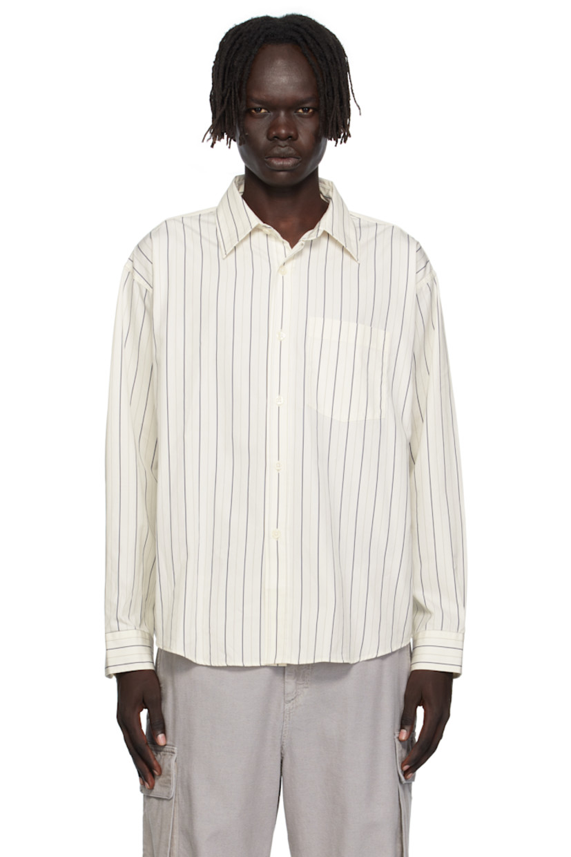 Deadstock cotton poplin shirt.

· Stripes throughout
· Spread collar
· Button closure
· Patch pocket at chest
· Shirttail hem
· Adjustable buttoned barrel cuffs
· Box pleat at back yoke

Available exclusively at SSENSE.

Supplier color: Fine weave stripe