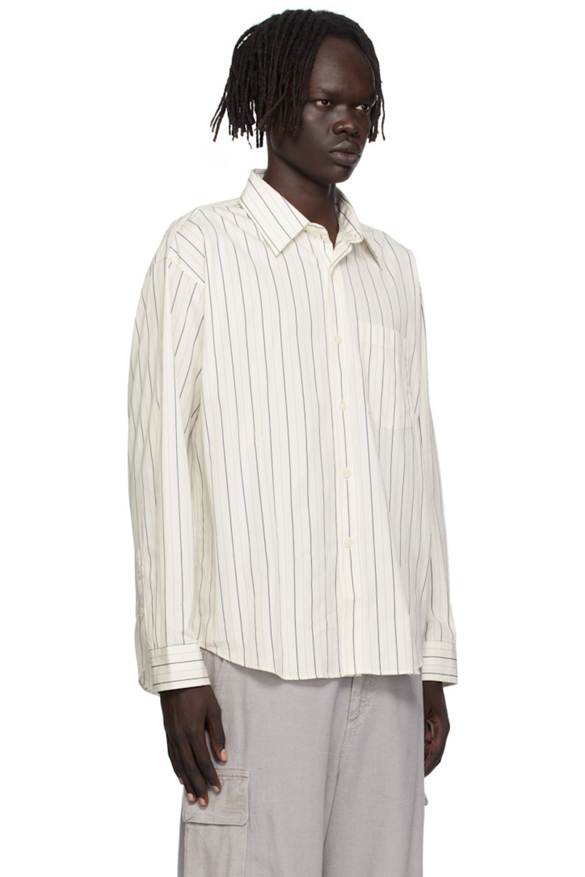 Deadstock cotton poplin shirt.

· Stripes throughout
· Spread collar
· Button closure
· Patch pocket at chest
· Shirttail hem
· Adjustable buttoned barrel cuffs
· Box pleat at back yoke

Available exclusively at SSENSE.

Supplier color: Fine weave stripe