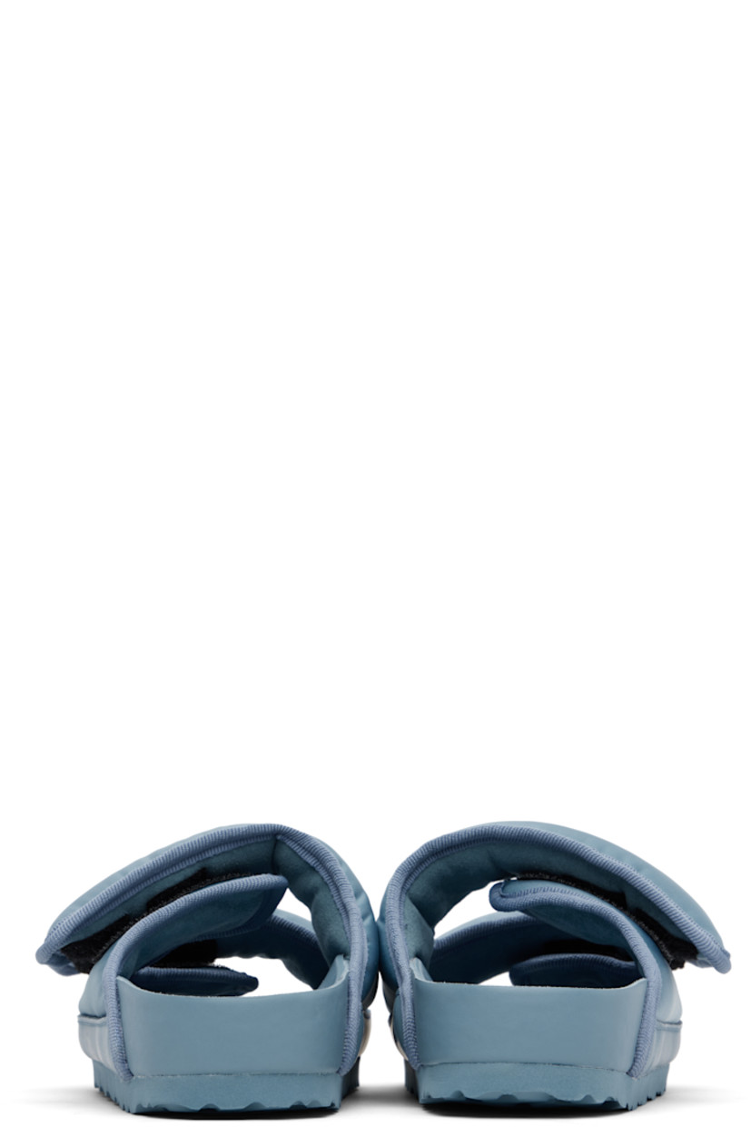 Padded nylon twill flat sandals.

· Grosgrain trim throughout 
· Velcro straps at vamp
· Covered and molded cork footbed
· Treaded rubber sole 

Supplier color: Faded denim