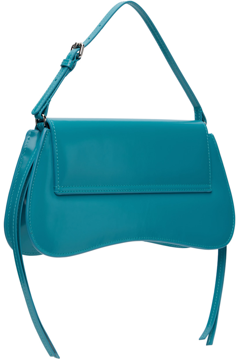 Polished leather top handle bag.

· Adjustable carry handle
· Silver-tone logo stamp at face
· Extended trim at sides
· Curved base
· Magnetic flap
· Patch pocket and D-ring at interior
· H5.25" x W11" x D2" 

Supplier color: Blue