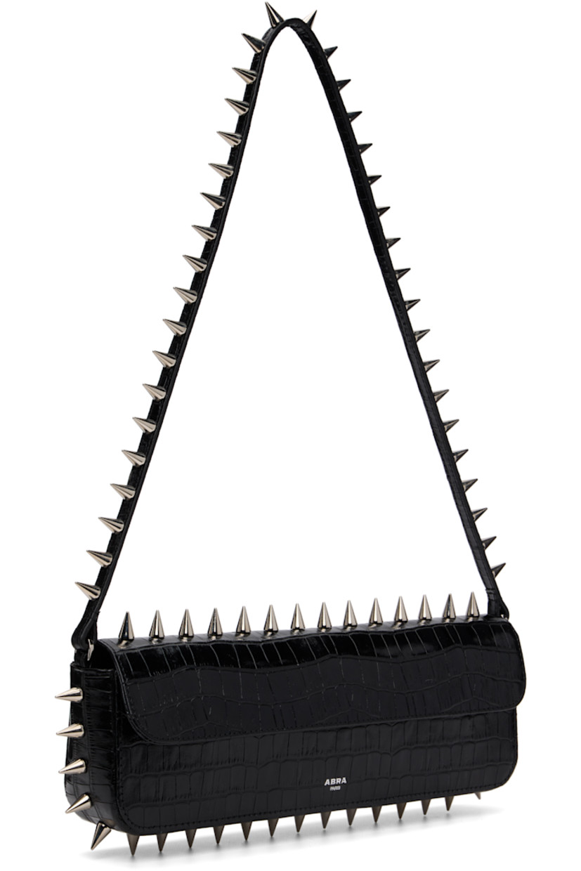 Structured croc-embossed leather shoulder bag.

· Studs throughout
· Fixed shoulder strap
· Silver-tone logo stamp at face
· Magnetic flap
· Patch pocket and D-ring at interior
· Silver-tone hardware
· H4" x W11.75" x D2"

Supplier color: Black crocco