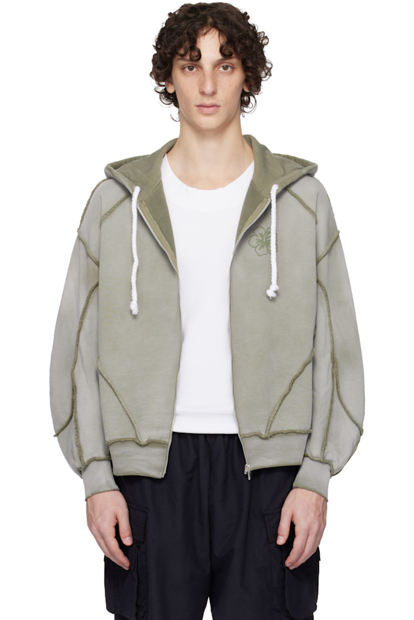 French terry hoodie. Exposed seams and fading throughout.

· Paneled construction
· Drawstring at hood
· Zip closure
· Logo graphic printed at chest
· Raglan sleeves
· Contrast stitching in khaki

Supplier color: Grey