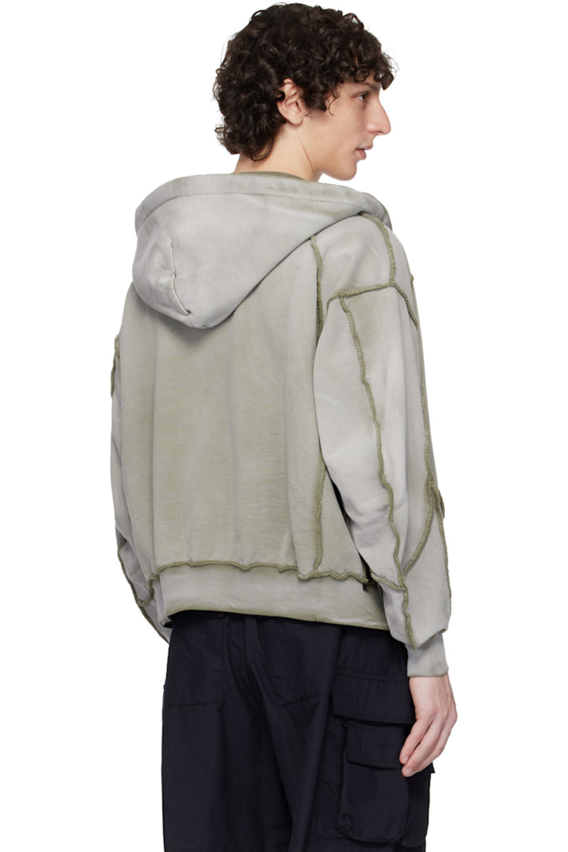 French terry hoodie. Exposed seams and fading throughout.

· Paneled construction
· Drawstring at hood
· Zip closure
· Logo graphic printed at chest
· Raglan sleeves
· Contrast stitching in khaki

Supplier color: Grey