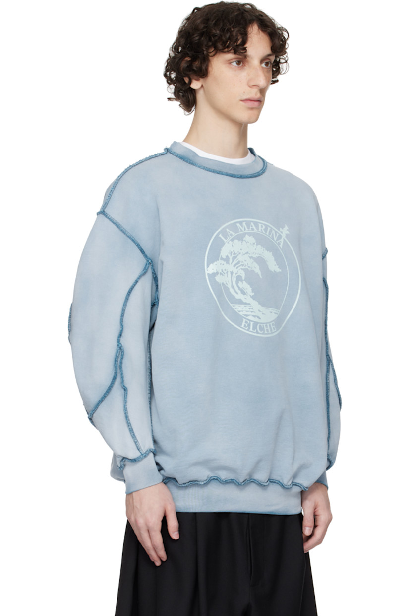 French terry sweatshirt. Discoloration and pinched seams throughout.

· Rib-knit crewneck, hem, and cuffs
· Text and graphic printed at front
· Dropped shoulders

Supplier color: Blue