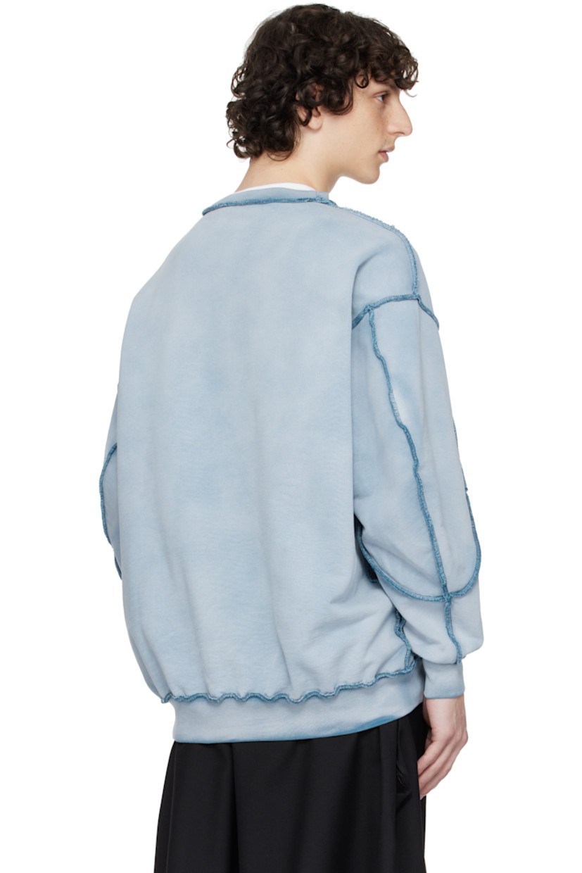 French terry sweatshirt. Discoloration and pinched seams throughout.

· Rib-knit crewneck, hem, and cuffs
· Text and graphic printed at front
· Dropped shoulders

Supplier color: Blue