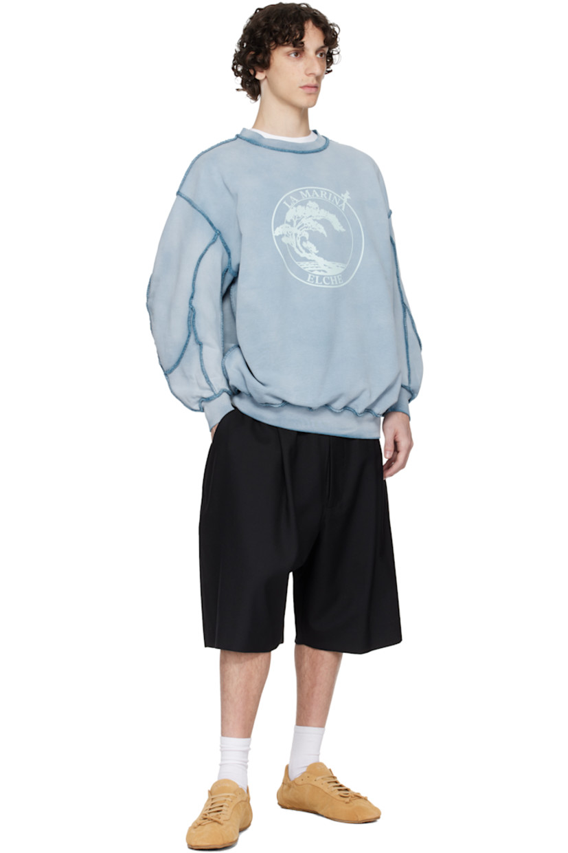 French terry sweatshirt. Discoloration and pinched seams throughout.

· Rib-knit crewneck, hem, and cuffs
· Text and graphic printed at front
· Dropped shoulders

Supplier color: Blue