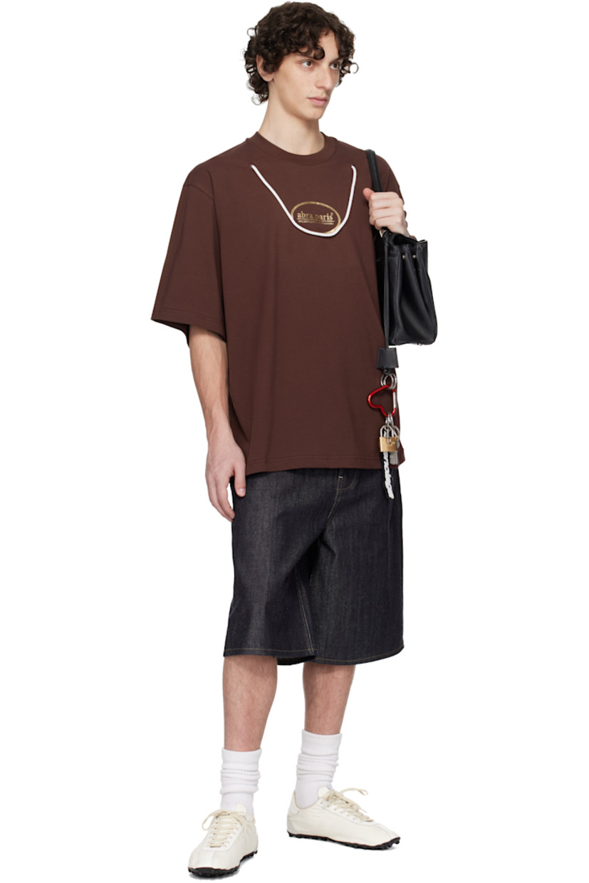 Cotton jersey T-shirt.

· Rib-knit crewneck
· Logo printed at chest
· Cord trim at front
· Dropped shoulders

Supplier color: Brown